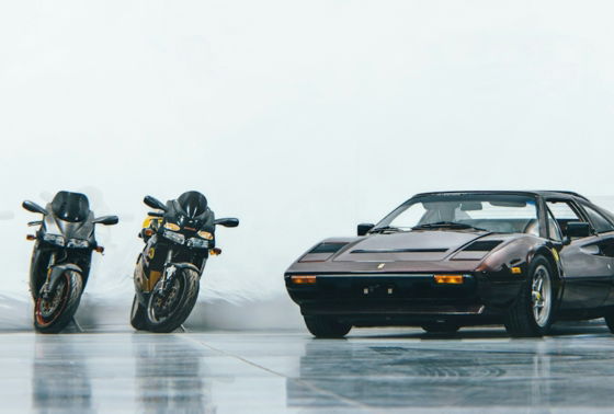 A group of motorcycles parked next to a car